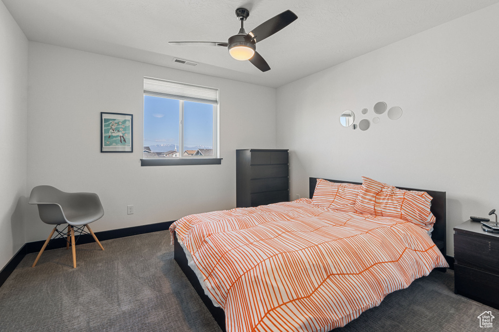 Bedroom with carpet, baseboards, and a ceiling fan