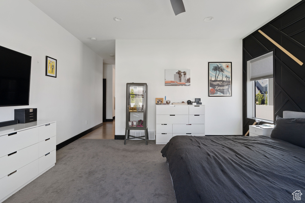 Bedroom with carpet, ceiling fan, and baseboards