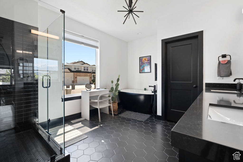 Bathroom with a soaking tub, tile patterned floors, a stall shower, and vanity