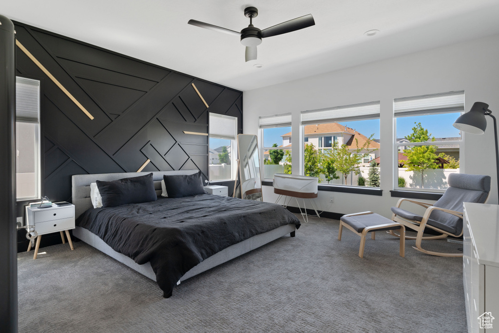 Bedroom featuring ceiling fan and carpet