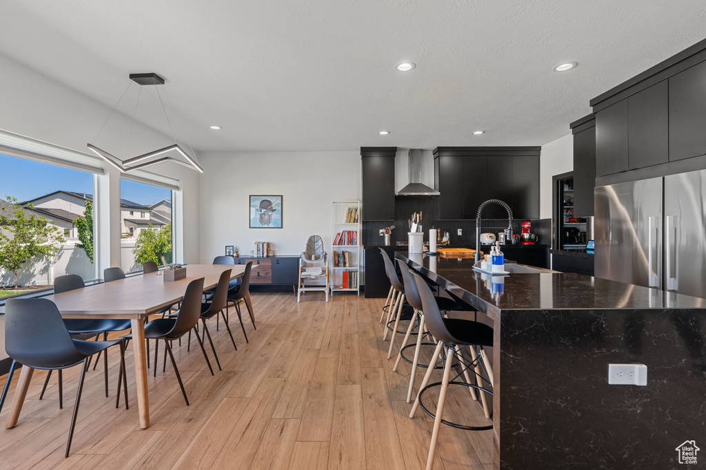Dining space with light wood-style flooring and recessed lighting
