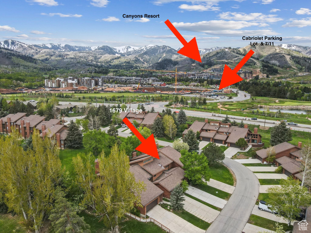 View of mountain background with a nearby body of water and nearby suburban area
