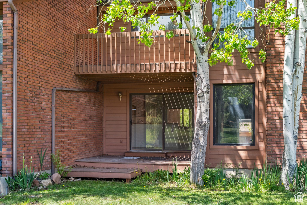 Entrance to property featuring brick siding
