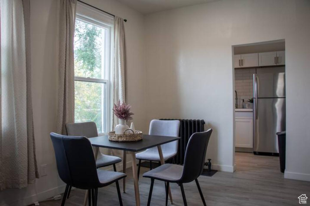 Dining space featuring light wood-style floors and baseboards