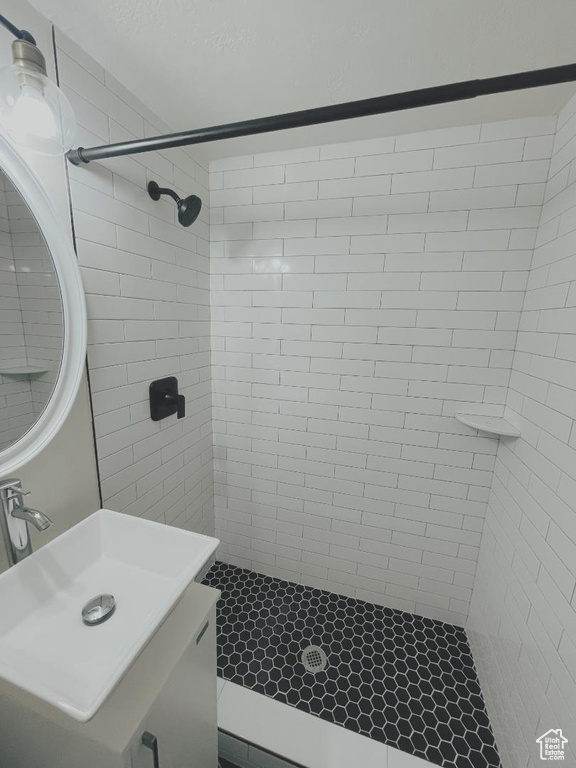 Full bathroom with tiled shower and vanity