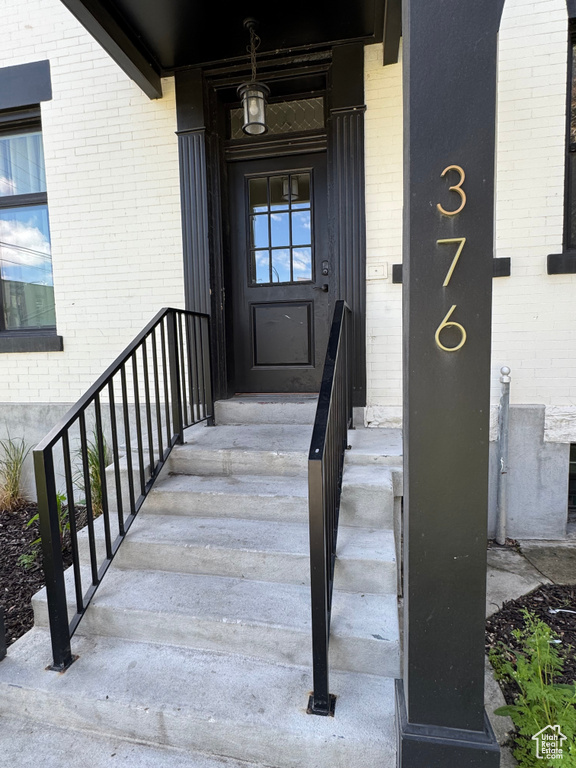 Doorway to property with brick siding