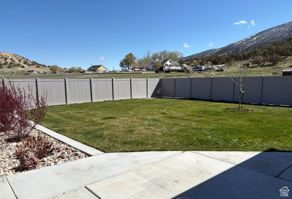 View of yard with a mountain view and a patio area