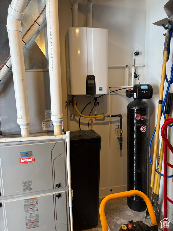 Utility room featuring tankless water heater