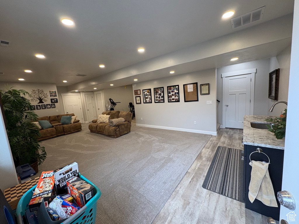 Living area featuring recessed lighting, baseboards, and light wood-style flooring