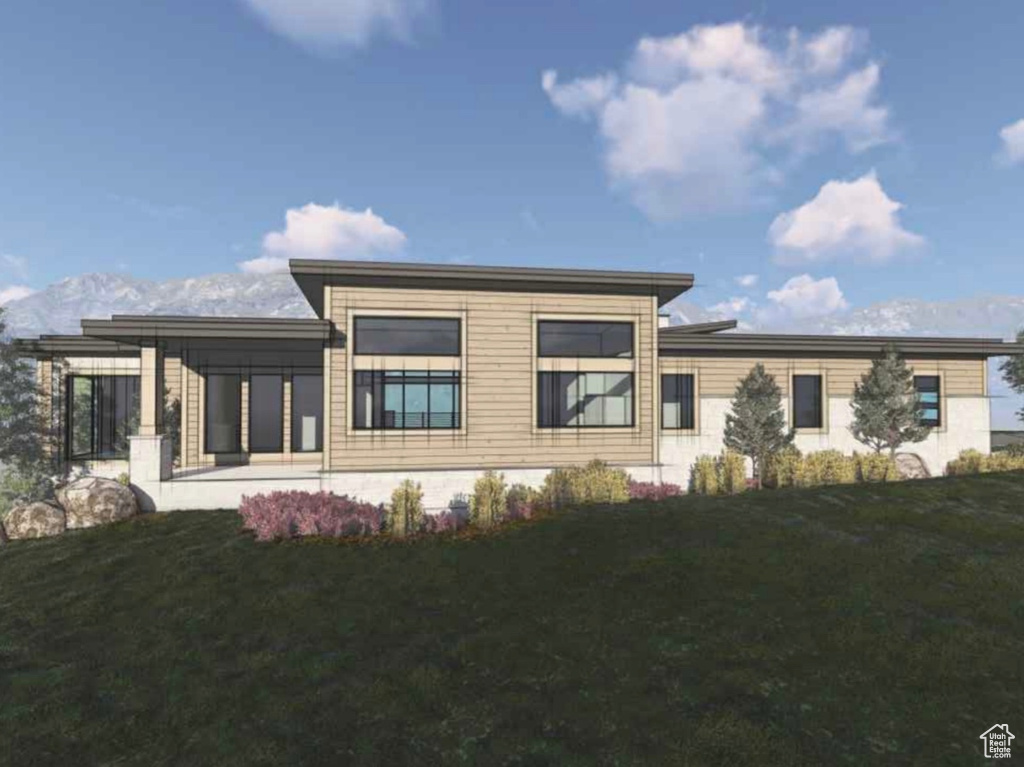 Contemporary home with a front yard, a mountain view, and a patio area