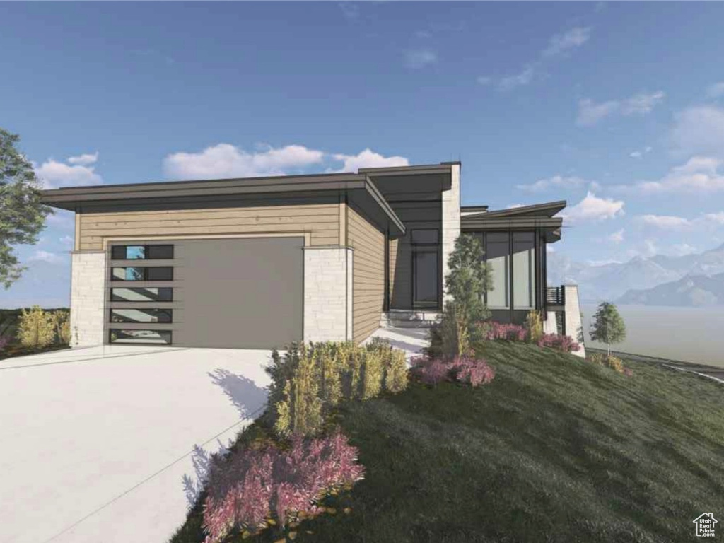 View of side of property featuring concrete driveway, an attached garage, and a mountain view