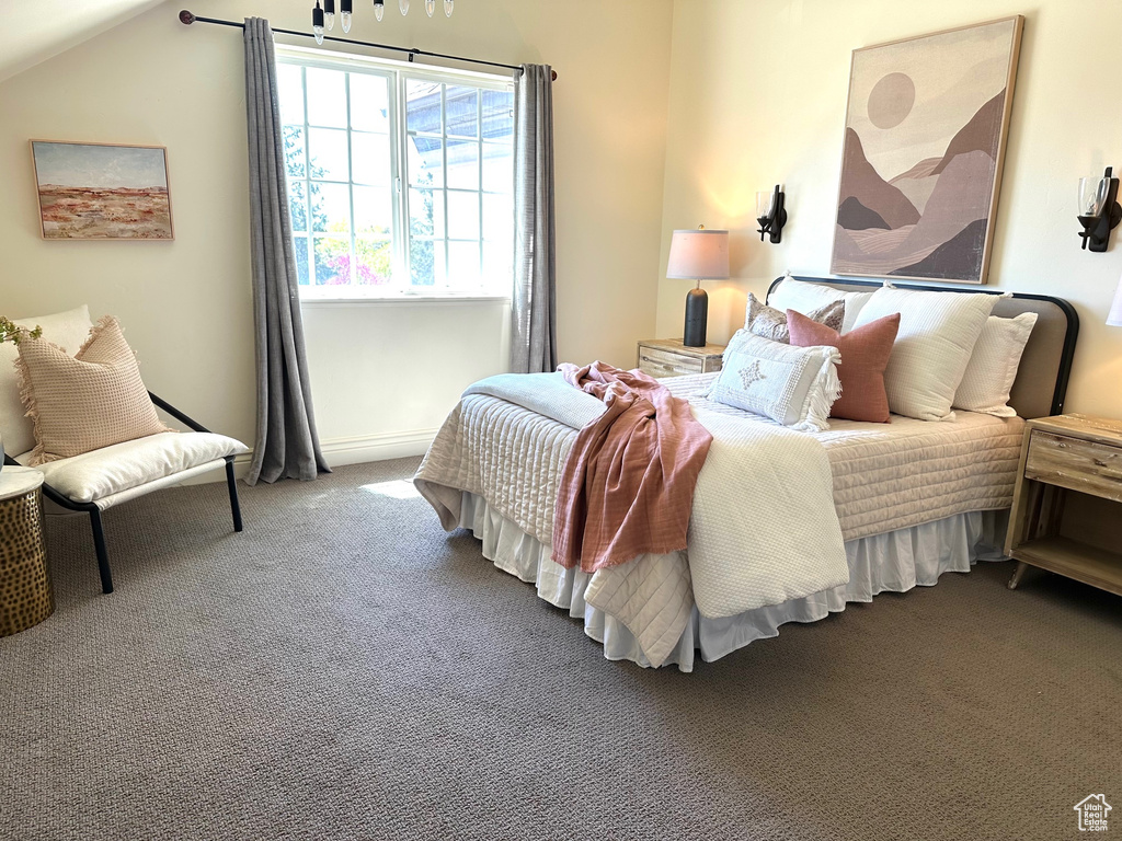 Bedroom with carpet and lofted ceiling