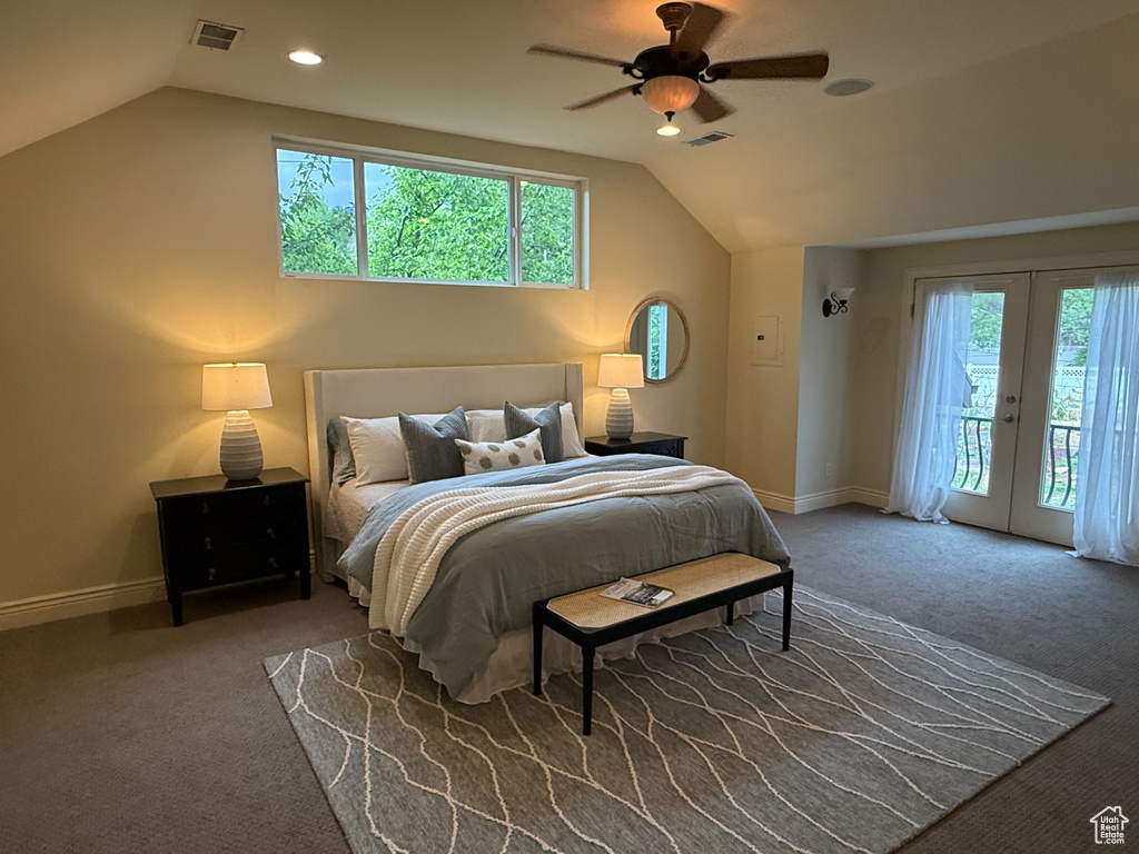 Bedroom featuring vaulted ceiling, access to exterior, multiple windows, carpet, and french doors