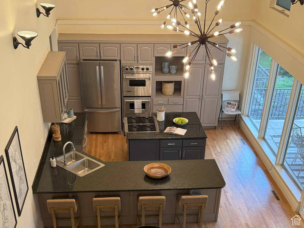Dining area featuring light wood finished floors, a chandelier, and baseboards
