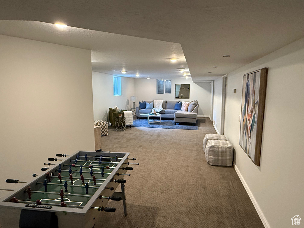 Recreation room with carpet flooring and baseboards