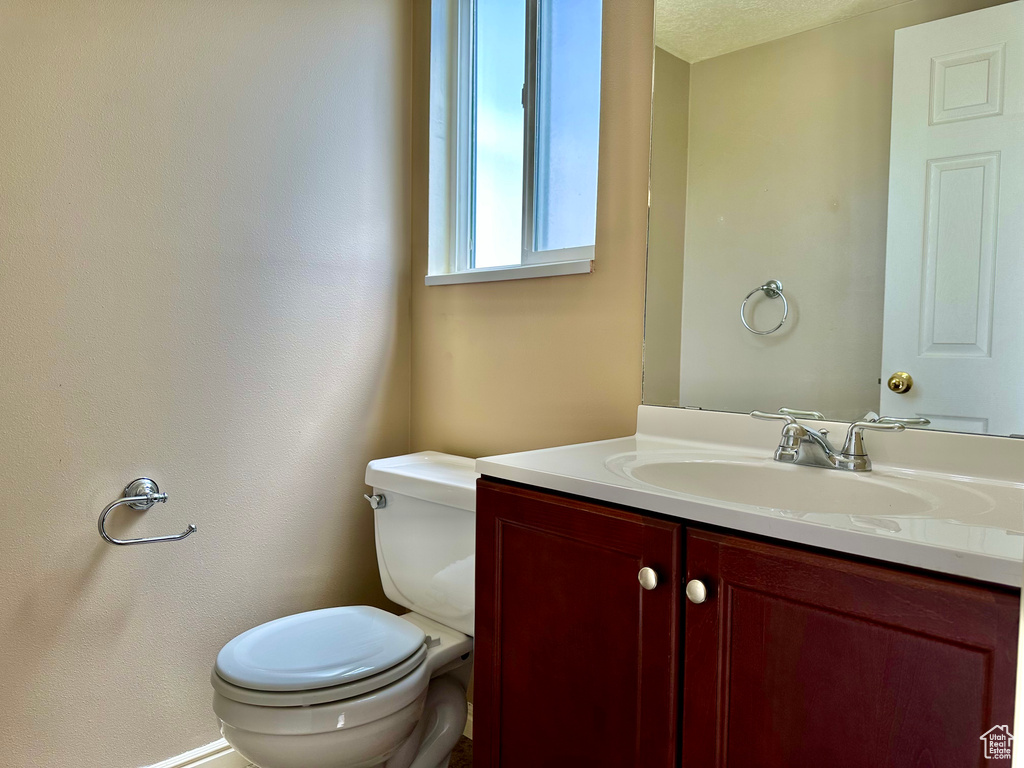 Bathroom featuring vanity and toilet