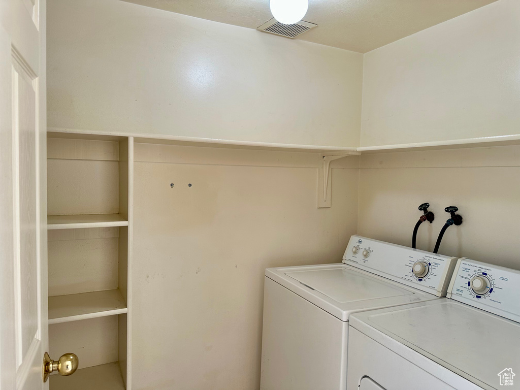 Laundry area with washing machine and clothes dryer