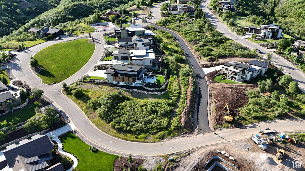 Aerial view of property and surrounding area featuring nearby suburban area