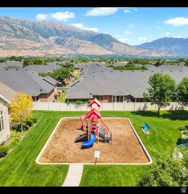 Community playground with a residential view and a mountain view