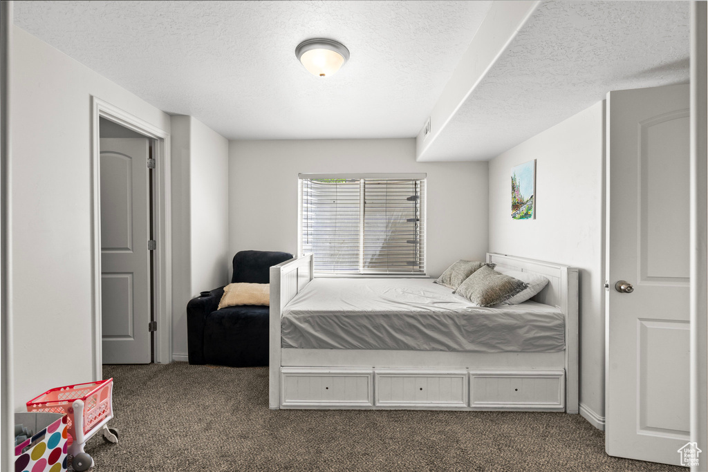 Bedroom with carpet flooring and a textured ceiling