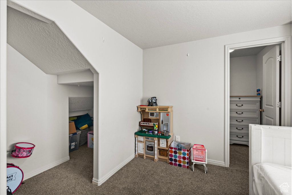 Carpeted bedroom with baseboards