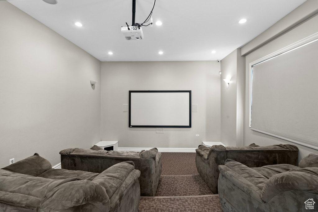 Home theater room with dark colored carpet, recessed lighting, and baseboards