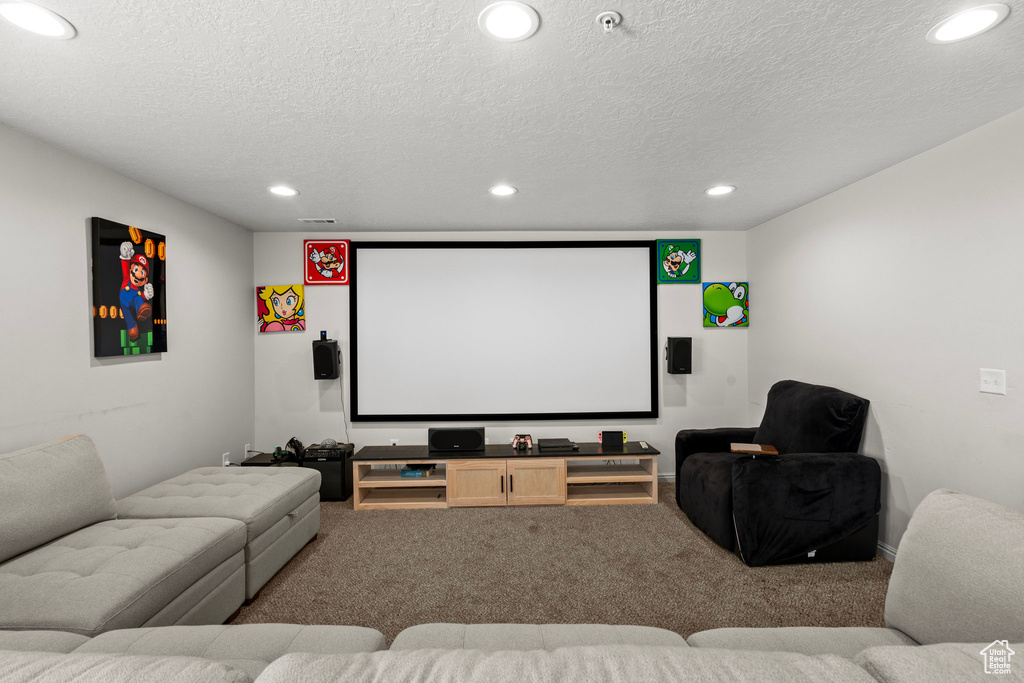 Carpeted home theater with recessed lighting and a textured ceiling