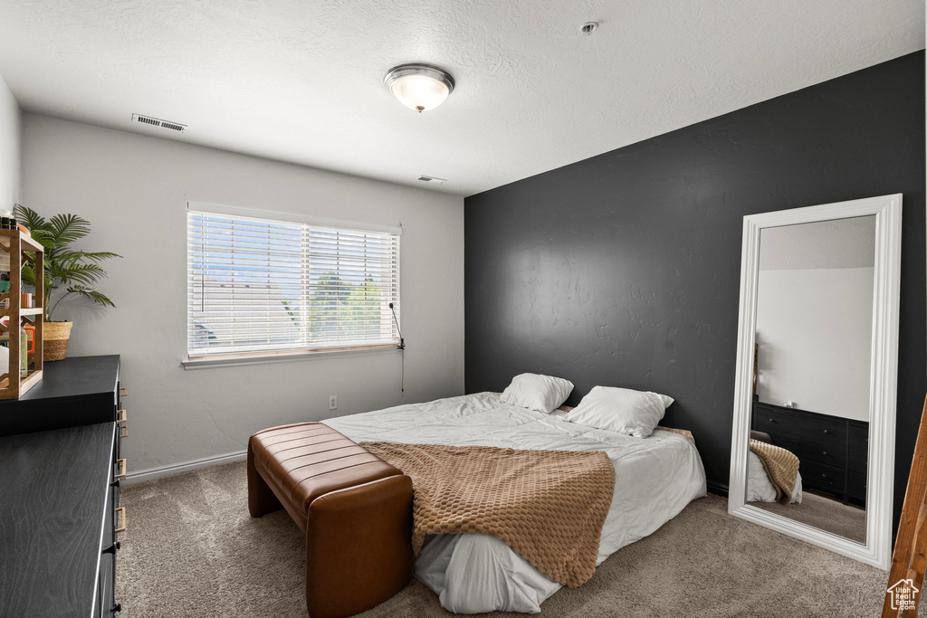 Bedroom with carpet floors and baseboards