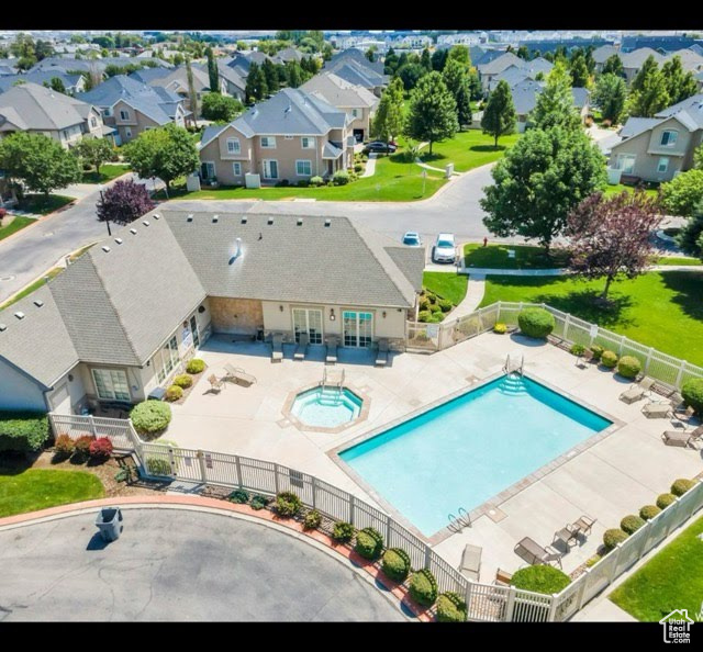 Aerial perspective of suburban area featuring a pool