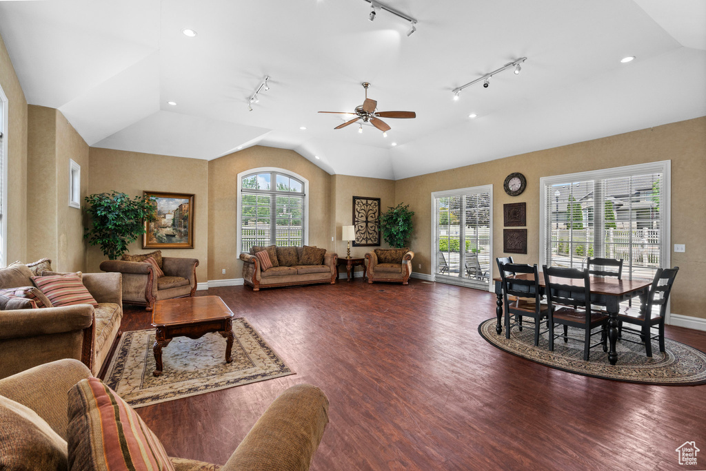 Living room with dark wood-type flooring, plenty of natural light, baseboards, vaulted ceiling, and recessed lighting