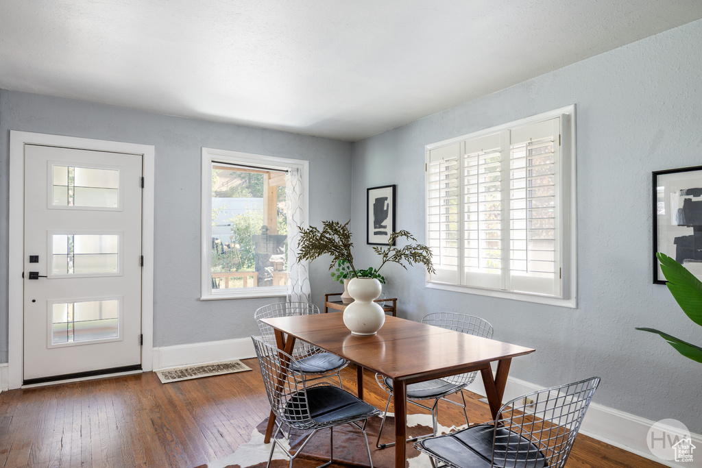 Dining space with hardwood / wood-style floors and baseboards