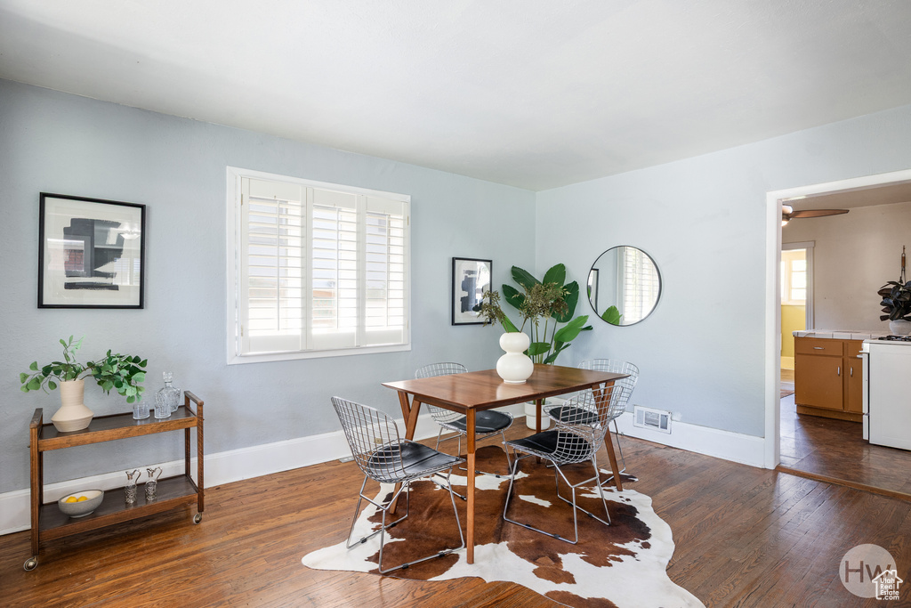 Dining room with wood finished floors and baseboards