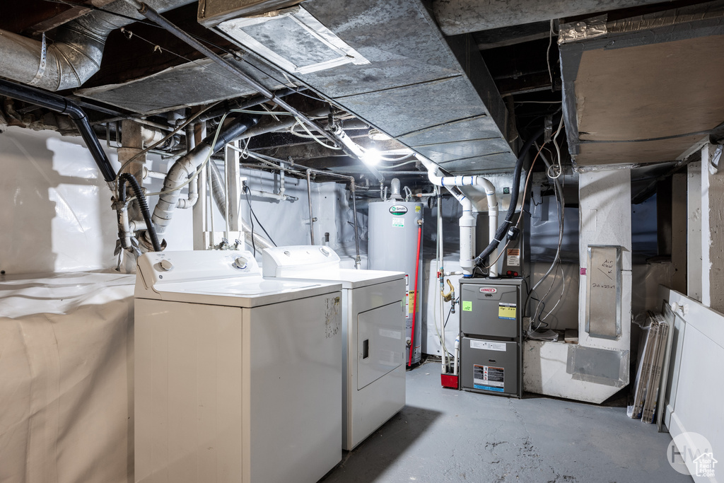 Unfinished basement featuring separate washer and dryer and water heater