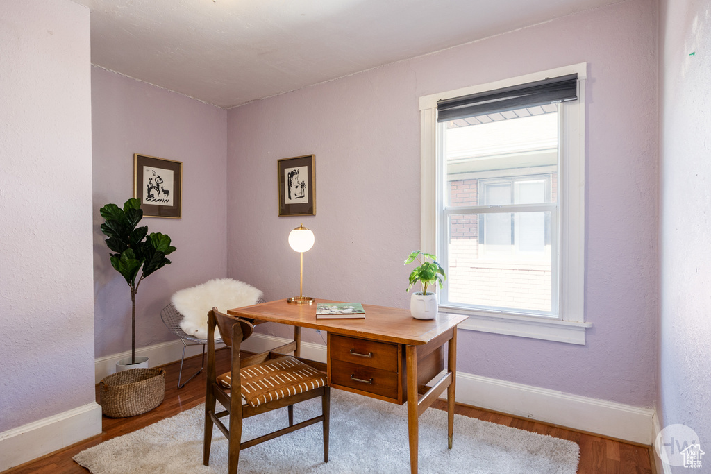 Office with wood finished floors and baseboards