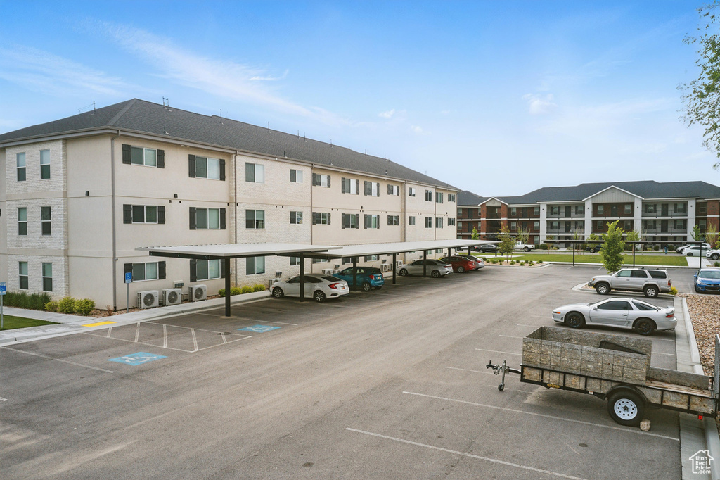 View of property with covered parking