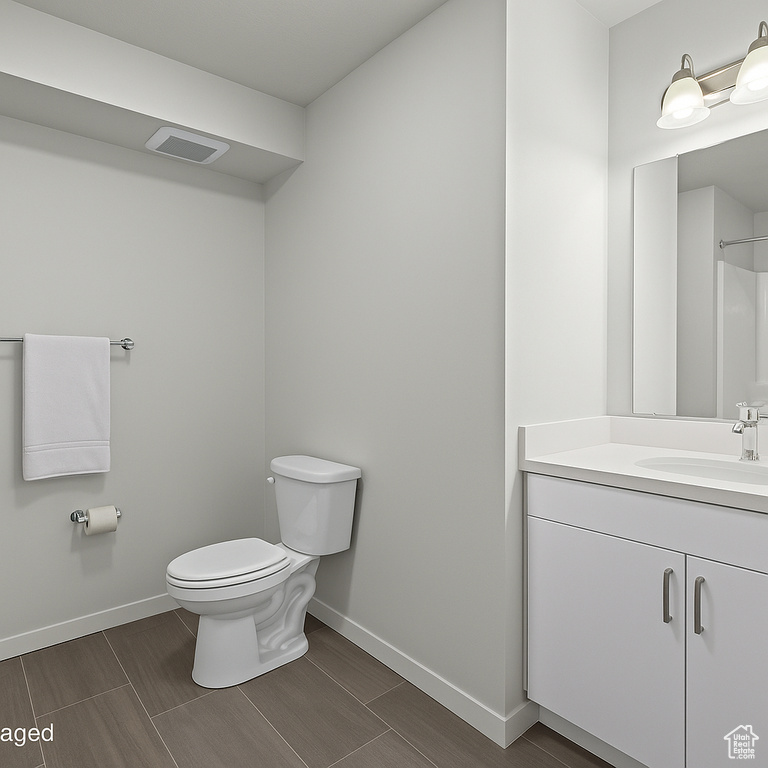 Bathroom with baseboards, toilet, vanity, and wood tiled floors