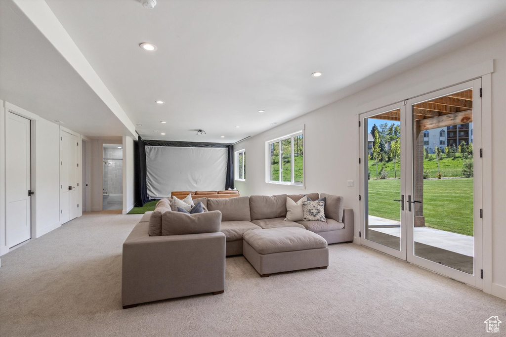 Living area featuring light carpet and recessed lighting