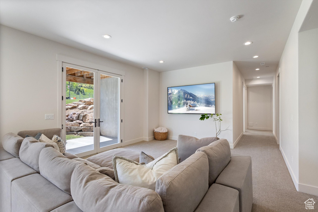 Living area featuring light carpet, recessed lighting, and baseboards