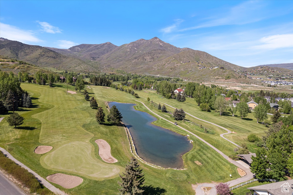 View of property location with a water and mountain view and a golf club