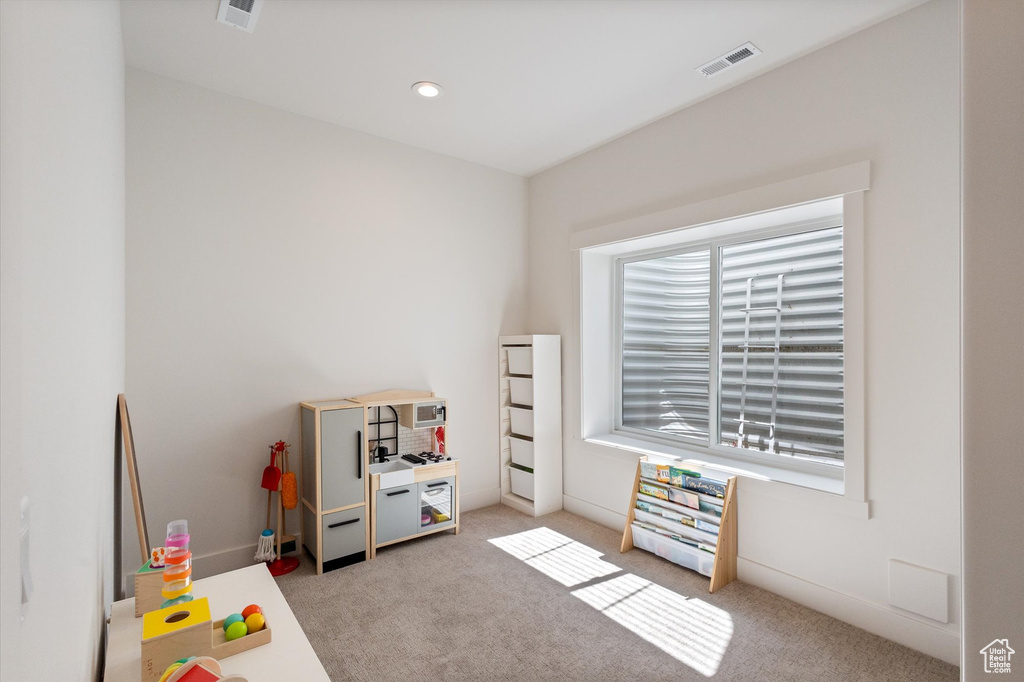 Recreation room featuring light colored carpet