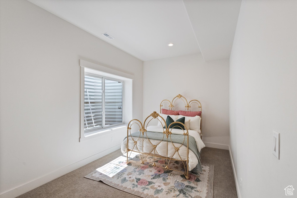 Carpeted bedroom with baseboards and recessed lighting