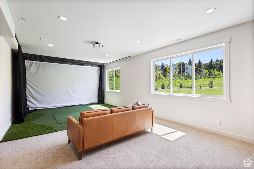 Cinema with golf simulator, light carpet, recessed lighting, and baseboards