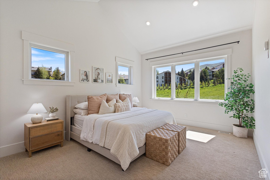 Bedroom featuring light carpet, lofted ceiling, recessed lighting, and baseboards