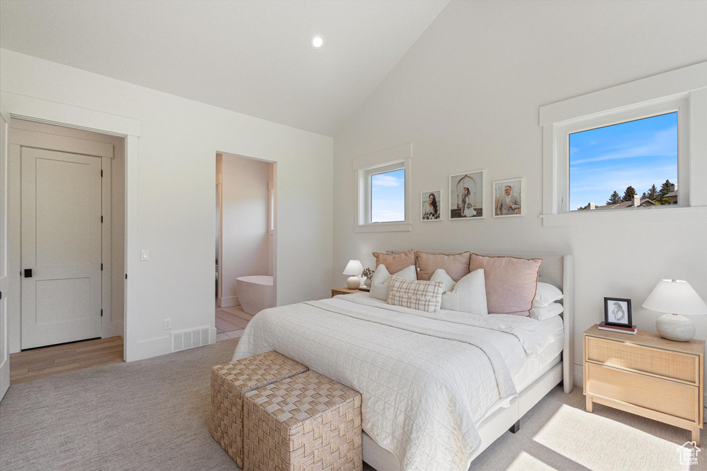 Bedroom featuring carpet, high vaulted ceiling, ensuite bathroom, and recessed lighting