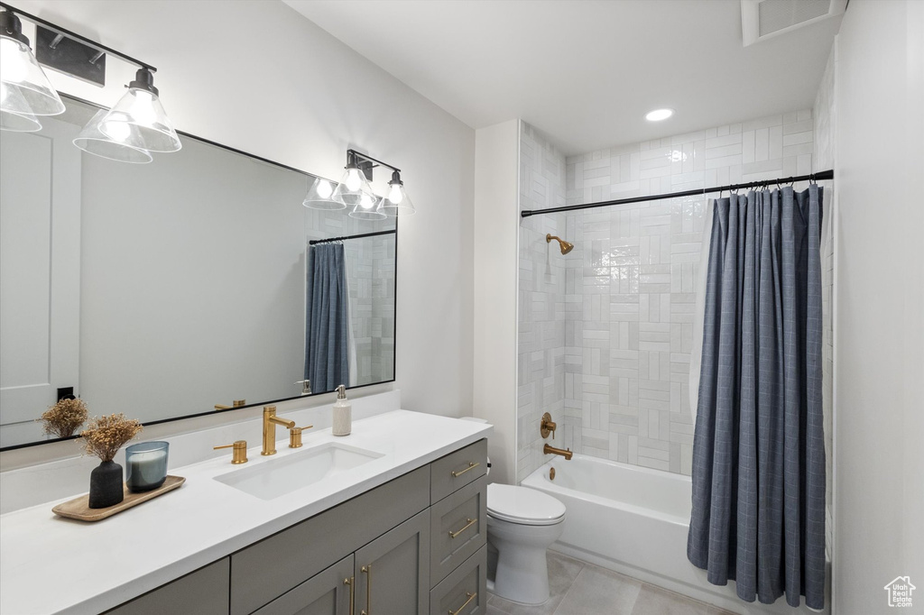 Full bathroom featuring vanity, toilet, shower / bath combo, tile patterned floors, and recessed lighting