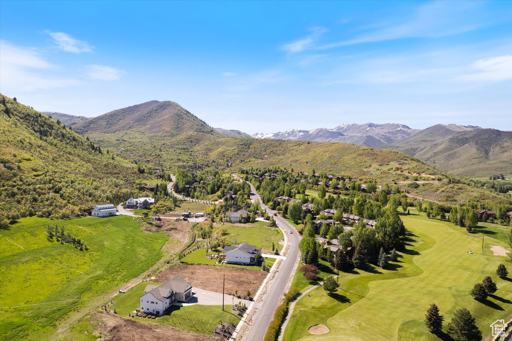 Drone / aerial view of a mountainous background and a golf course