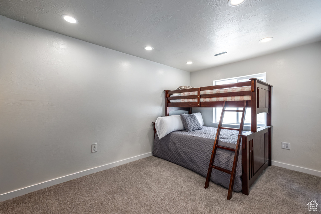 Carpeted bedroom featuring recessed lighting and baseboards