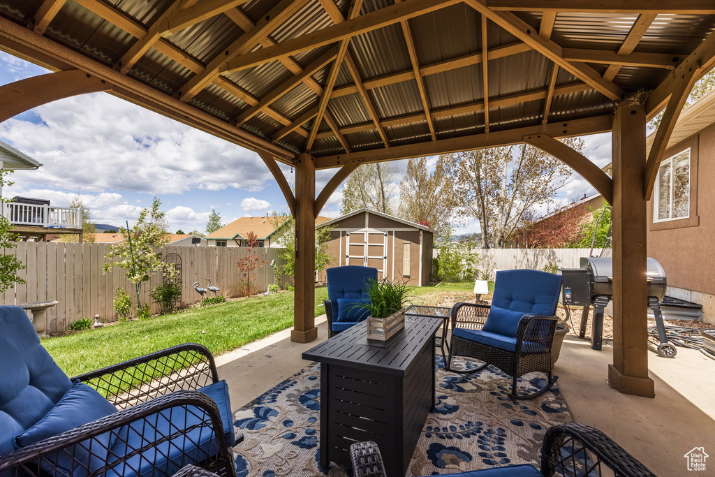 View of patio featuring a gazebo, outdoor lounge area, and grilling area