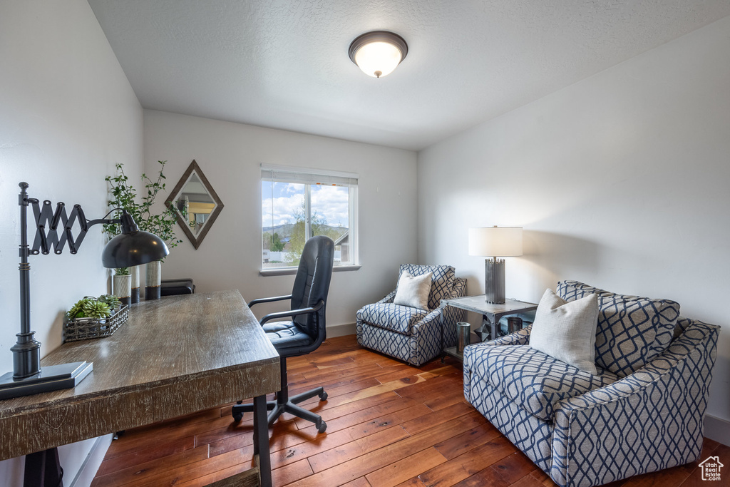 Home office featuring hardwood / wood-style flooring and baseboards