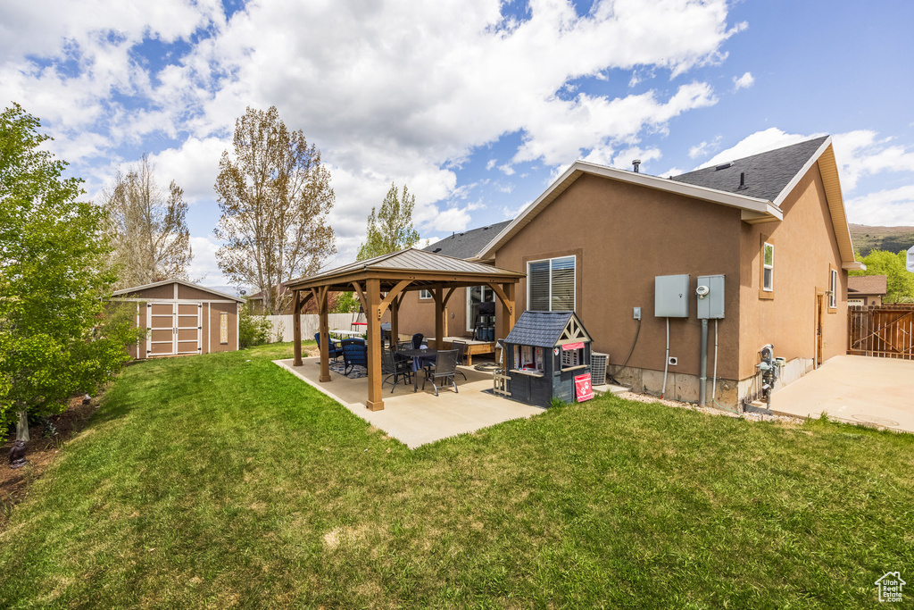 Back of property with a patio, a gazebo, and stucco siding